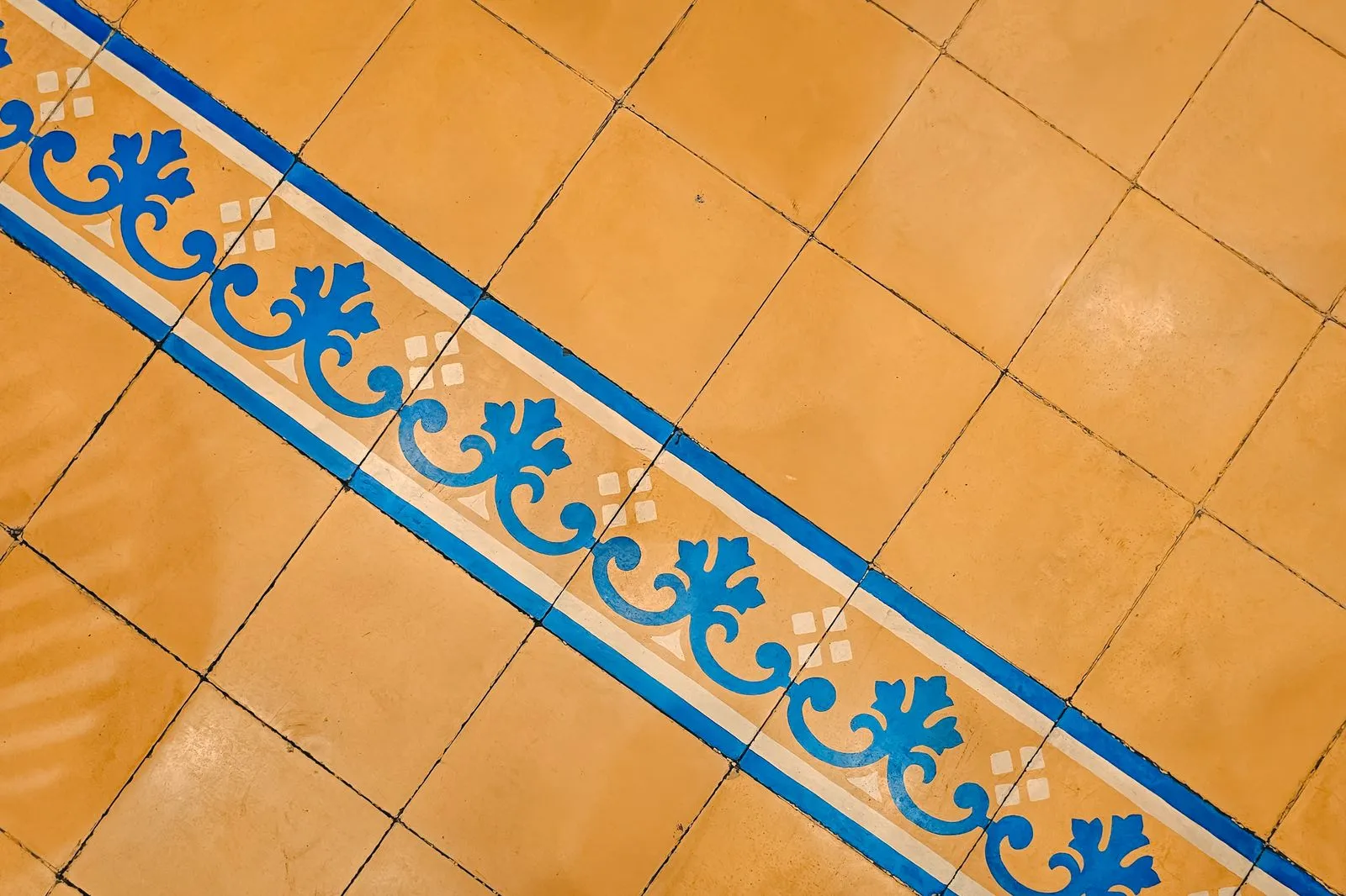 Carreaux de ciment ocre avec frise bleue
